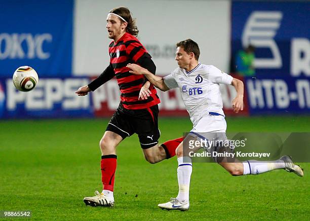 Igor Semshov of FC Dynamo Moscow battles for the ball with Denis Dedechko of FC Amkar Perm during the Russian Football League Championship match...