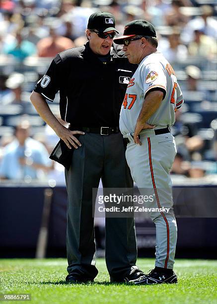 Paul Emmel, home plate umpire talks with manager Dave Trembley of the Baltimore Orioles after Emmel ejected pitching coach Rick Kranitz at Yankee...