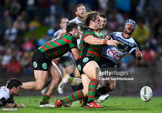 Johnathan Thurston of the Cowboys is tackled by Angus Crichton and George Burgess of the Rabbitohs during the round 16 NRL match between the South...