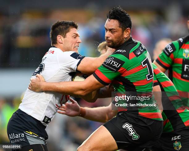 Corey Jensen of the Cowboys is tackled by John Sutton of the Rabbitohs during the round 16 NRL match between the South Sydney Rabbitohs and the North...