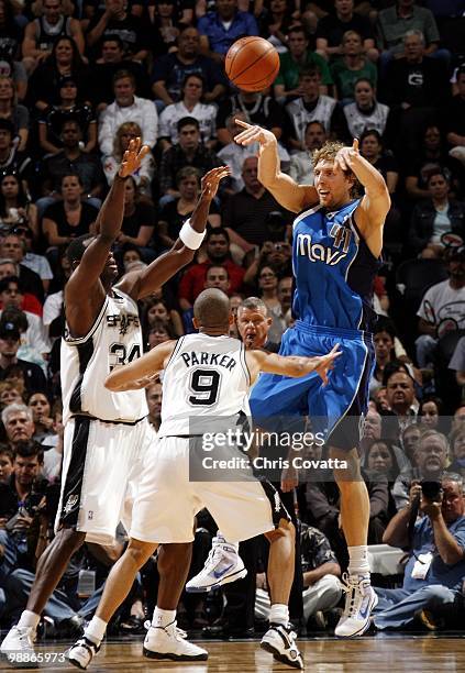 Dirk Nowitzki of the Dallas Mavericks passes against Antonio McDyess and Tony Parker of the San Antonio Spurs in Game Four of the Western Conference...