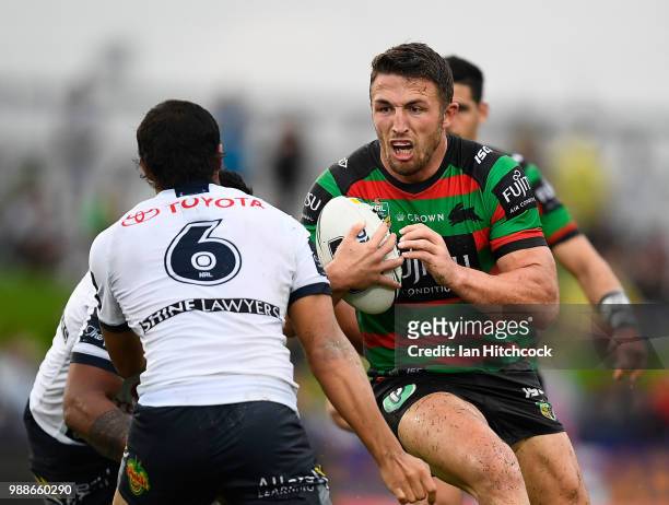 Sam Burgess of the Rabbitohs looks to get past Enari Tuala of the Cowboys during the round 16 NRL match between the South Sydney Rabbitohs and the...