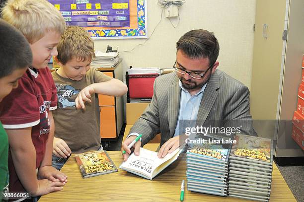 Author Eric Wight signs copies of his new books Frankie Pickle for the students of Harry S. Truman school at the donation of $1000 in OfficeMax...