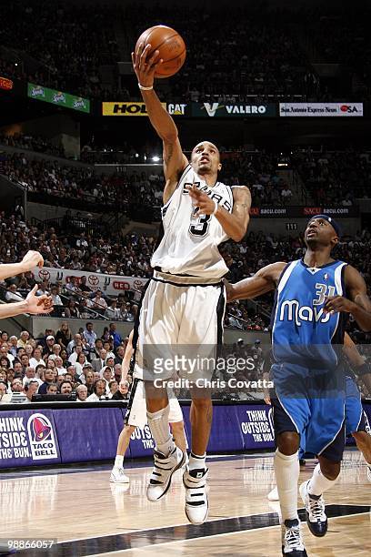 George Hill of the San Antonio Spurs shoots a layup against Jason Terry of the Dallas Mavericks in Game Four of the Western Conference Quarterfinals...
