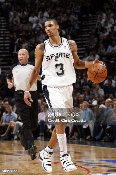 George Hill of the San Antonio Spurs moves the ball up court against the Dallas Mavericks in Game Four of the Western Conference Quarterfinals during...