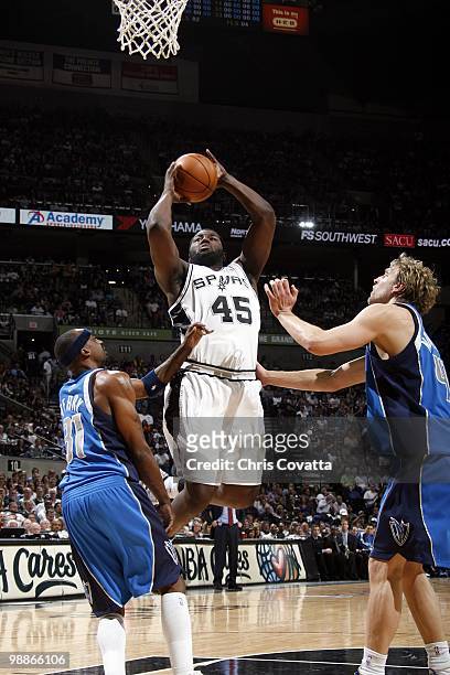 DeJuan Blair of the San Antonio Spurs goes up for a shot against Jason Terry and Dirk Nowitzki of the Dallas Mavericks in Game Four of the Western...