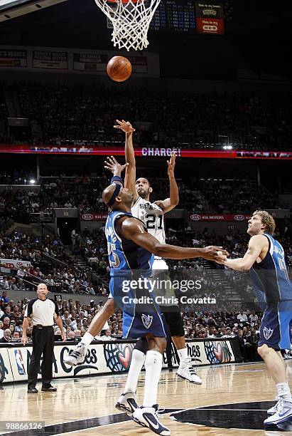 Tim Duncan of the San Antonio Spurs puts up a shot against Erick Dampier and Dirk Nowitzki of the Dallas Mavericks in Game Four of the Western...