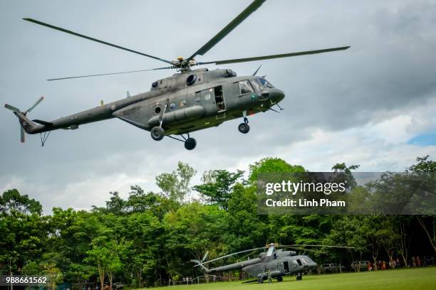 Thai Airforce workers and drill experts prepare for a scouting flight by helicopter from stadium on Doi Nang Non mountain range on July 1, 2018 in...