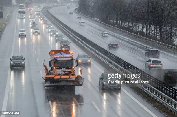 Gritting and snow clearing vehicle in falling snow on the Autobahn A8 motorway between Munich and Salzburg in Irschenberg, Germany, 08 December 2017....