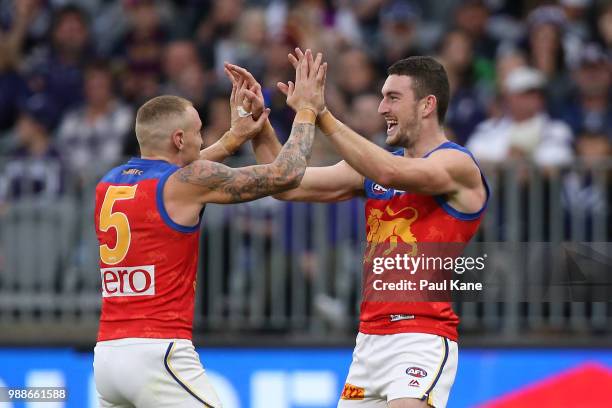 Daniel McStay and Mitch Robinson of the Lions celebrate a goal during the round 15 AFL match between the Fremantle Dockers and the Brisbane Lions at...