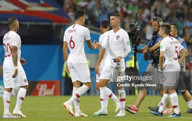 Portugal's Cristiano Ronaldo shakes hands with his teammate Jose Fonte after a 2-1 loss to Uruguay in a World Cup round-of-16 match in Sochi, Russia,...