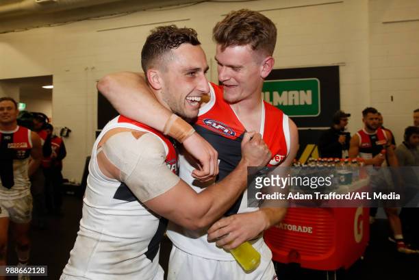 Luke Dunstan of the Saints celebrates with Debutant, Darragh Joyce of the Saints during the 2018 AFL round 15 match between the Melbourne Demons and...