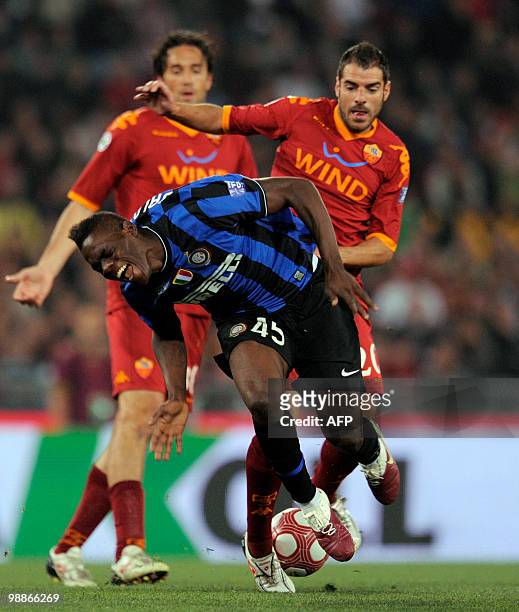 Inter Milan's forward Mario Balotelli is tackled by an AS Roma player during the Coppa Italia final on May 5, 2010 at Olimpico stadium in Rome. AFP...