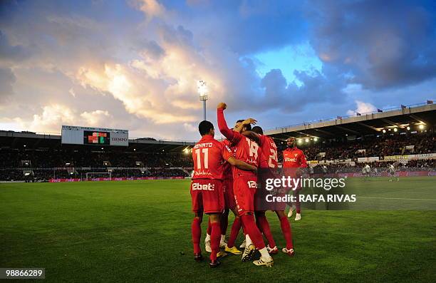 Sevilla's midfielder Alvaro Negredo celebrates with teammates after scoring against Racing Santander during a Spanish league football match, on May 5...