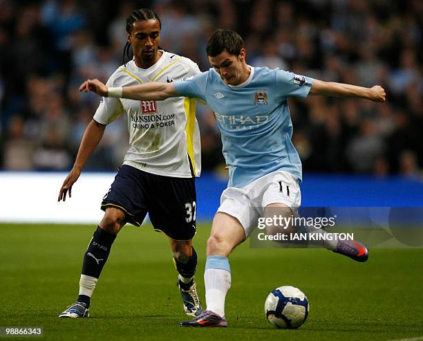 Manchester City's Adam Johnson vies for the ball with Tottenham Hotspurs Cameroon player Benoit Assou-Ekotto during a Premier League match at the...