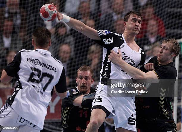 Momir Ilic of Kiel battles for the ball with Maximilian Weiss and Patrick Foelser of Duesseldorf during the Toyota Handball Bundesliga match between...