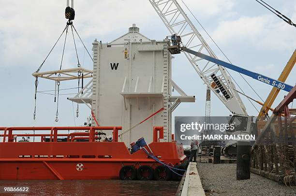 The Pollution Control Dome is lifted onboard an oil workboat in Port Fourchon, as it makes it way to cap the source of the oil slick from the BP...