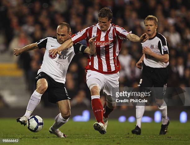 Danny Murphy of Fulham battles with Robert Huth of Stoke City during the Barclays Premier League match between Fulham and Stoke City at Craven...