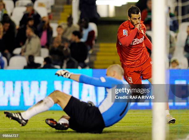 Sevilla's midfielder Alvaro Negredo celebrates scoring his second goal, his team's fifth one, next to Racing's goalkeeper Swiss Fabio Coltorti ,...