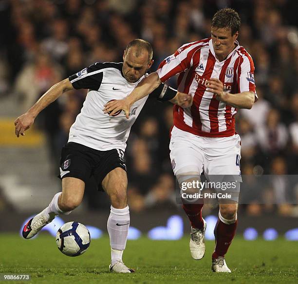 Danny Murphy of Fulham battles with Robert Huth of Stoke City during the Barclays Premier League match between Fulham and Stoke City at Craven...