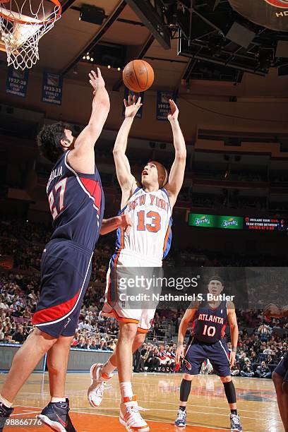 Sergio Rodriguez of the New York Knicks puts a shot up against Zaza Pachulia of the Atlanta Hawks during the game on March 8, 2010 at Madison Square...