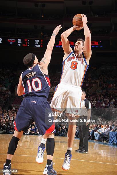 Danilo Gallinari of the New York Knicks makes a jumpshot against Mike Bibby of the Atlanta Hawks during the game on March 8, 2010 at Madison Square...