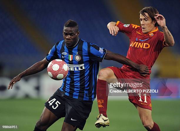 Roma's Brazilian midfielder Rodrigo Ferrante Taddei fights for the ball with Inter Milan's forward Mario Balotelli during the Coppa Italia final on...