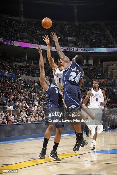 Russell Westbrook of the Oklahoma City Thunder puts a shot up against Wesley Matthews and Paul Millsap of the Utah Jazz on March 14, 2010 at the Ford...