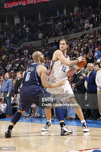 Nenad Krstic of the Oklahoma City Thunder looks to move the ball against Carlos Boozer of the Utah Jazz on March 14, 2010 at the Ford Center in...
