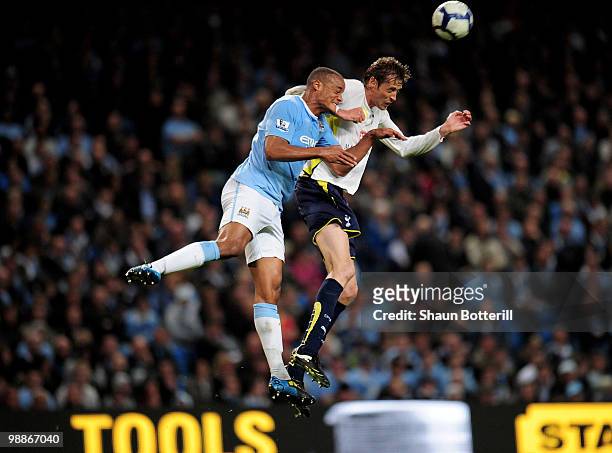 Peter Crouch of Tottenham Hotspur competes for the ball in the air with Vincent Kompany of Manchester City during the Barclays Premier League match...