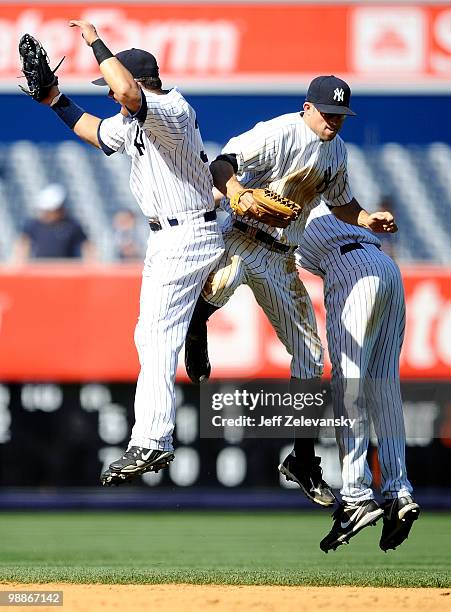 Nick Swisher , Brett Gardner and Robinson Cano of the New York Yankees celebrate a win and series sweep over the Baltimore Orioles at Yankee Stadium...