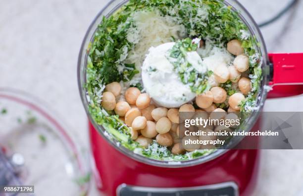 pesto preparation with macademia nuts. - food processor stock pictures, royalty-free photos & images