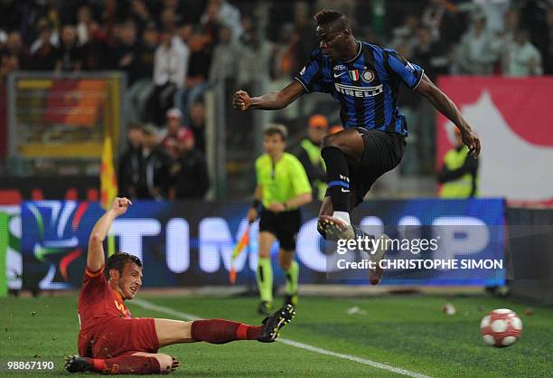 Inter Milan's forward Mario Balotelli jumps as AS Roma's defender Marco Motta tackles during their Coppa Italia final on May 5, 2010 at Olimpico...