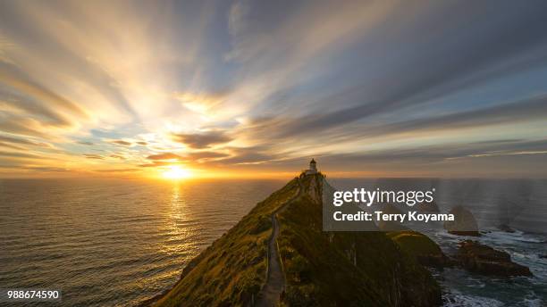 lighthouse on nugget point, otago, south island, new zealand. - nugget point stock pictures, royalty-free photos & images