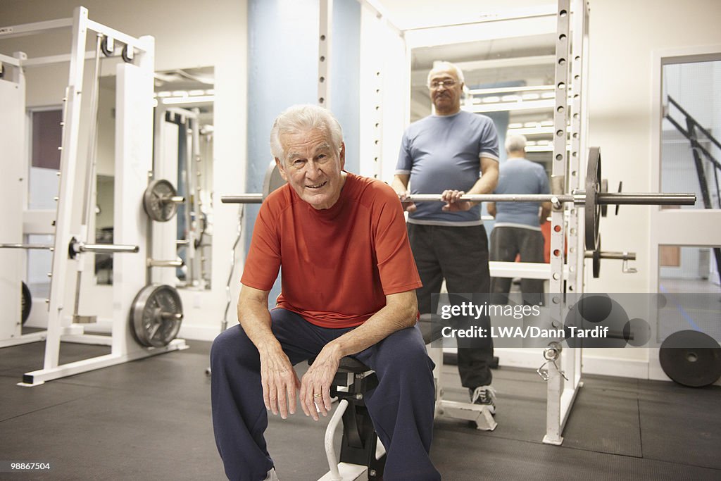 Senior men working out in health club