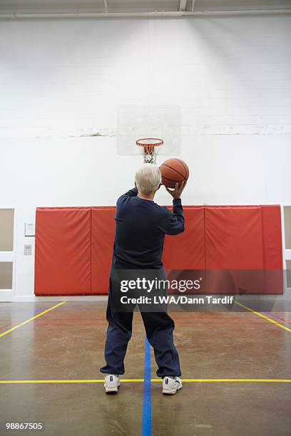 senior caucasian man playing basketball - old basketball hoop stock pictures, royalty-free photos & images