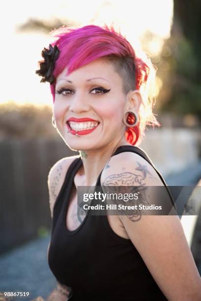 smiling, tattooed hispanic woman - gardena california stock pictures, royalty-free photos & images
