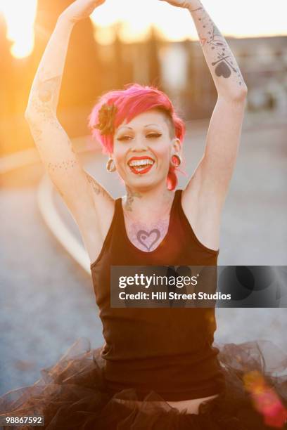 tattooed hispanic woman in tutu - gardena california fotografías e imágenes de stock