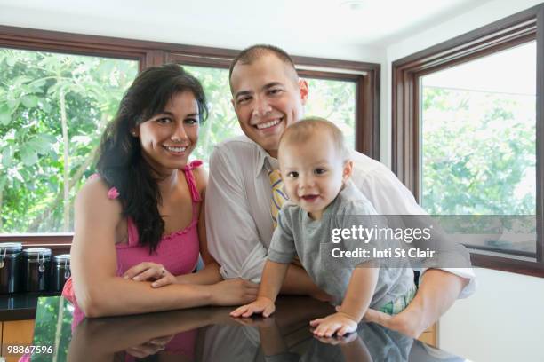 family smiling in kitchen - inti st clair stock pictures, royalty-free photos & images