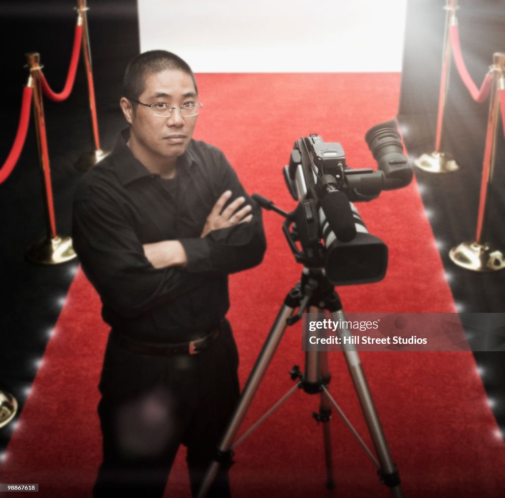 Chinese cameraman on red carpet with camera