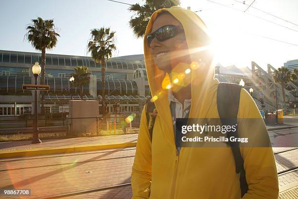 mixed race woman in hoody and sunglasses walking - coronado island stockfoto's en -beelden