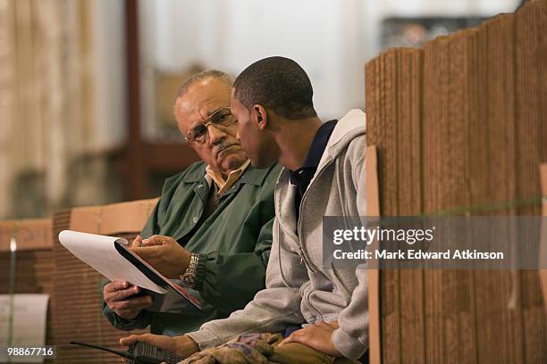 manager questioning worker in warehouse - luggage holds stock pictures, royalty-free photos & images