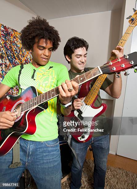friends playing guitar together - electric guitar stock pictures, royalty-free photos & images