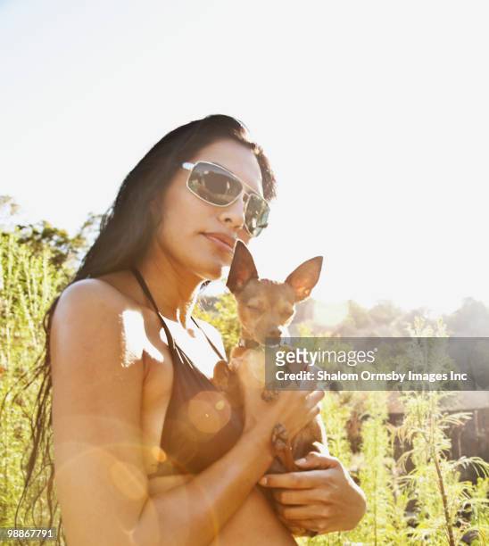 hispanic woman in bikini holding dog - san rafael california stock pictures, royalty-free photos & images