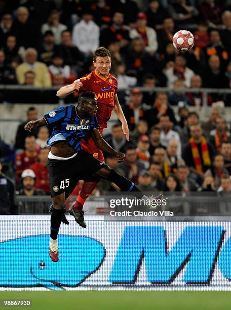Marco Motta of AS Roma competes for the ball with Mario Balotelli of FC Internazionale Milano during the Tim Cup between FC Internazionale Milano and...