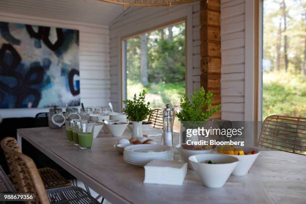 Fresh fruit and juices sit on a table in the dining area of a guest cabin on SuperShe island near Raasepori, Finland, on Wednesday, June 27, 2018....