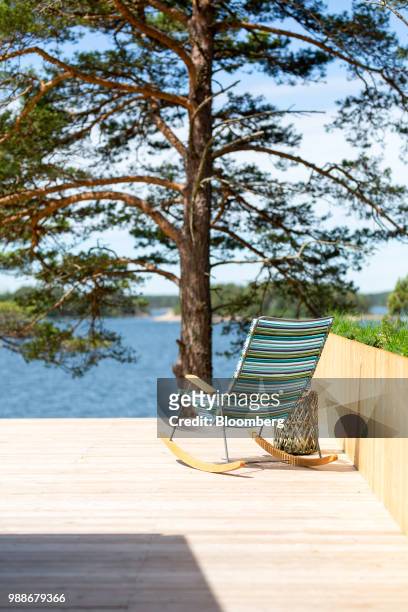 Rocking deckchair sits on a terrace looking out to the Baltic sea on SuperShe island near Raasepori, Finland, on Wednesday, June 27, 2018. The price...