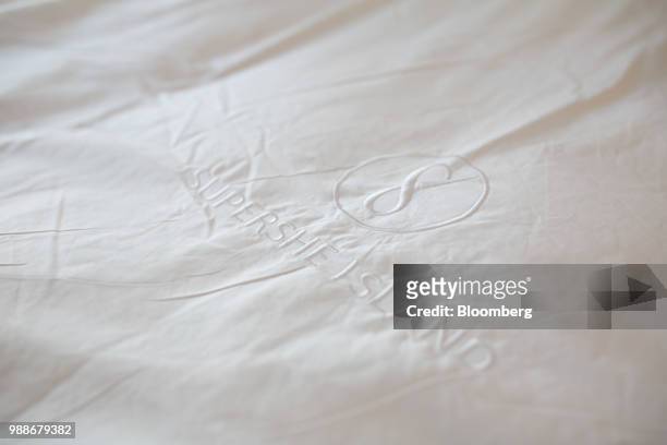 The SuperShe island logo sits embroidered on to bed sheets in a guest cabin on SuperShe island near Raasepori, Finland, on Wednesday, June 27, 2018....
