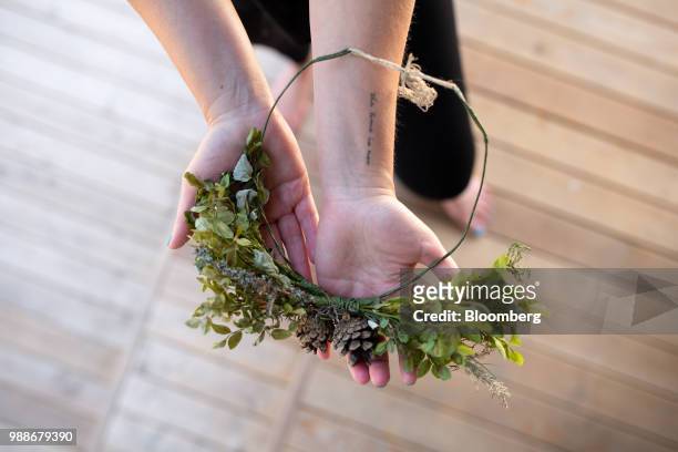 Kristina Roth, founder of the SuperShe network, holds a wreath on SuperShe island near Raasepori, Finland, on Wednesday, June 27, 2018. The price of...