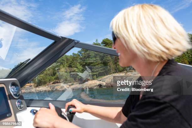 Kristina Roth, founder of the SuperShe network, drives a boat from SuperShe island near Raasepori, Finland, on Wednesday, June 27, 2018. The price of...